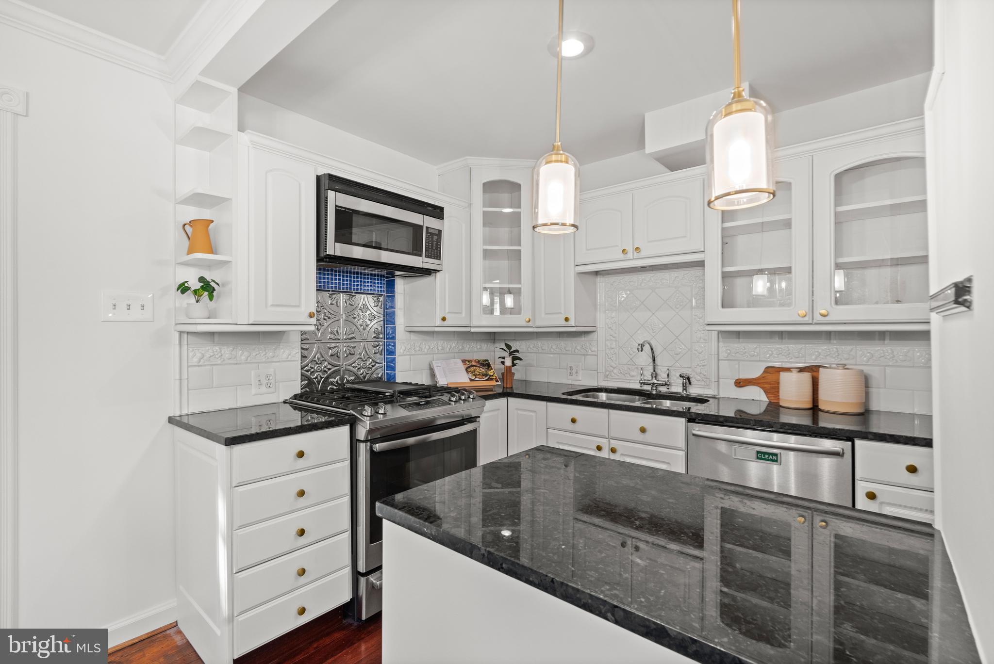 307 East Oxford Avenue, Unit 1/2 Alexandria, VA 22301 - Photo 8 of 34 a kitchen with granite countertop a sink stainless steel appliances and cabinets