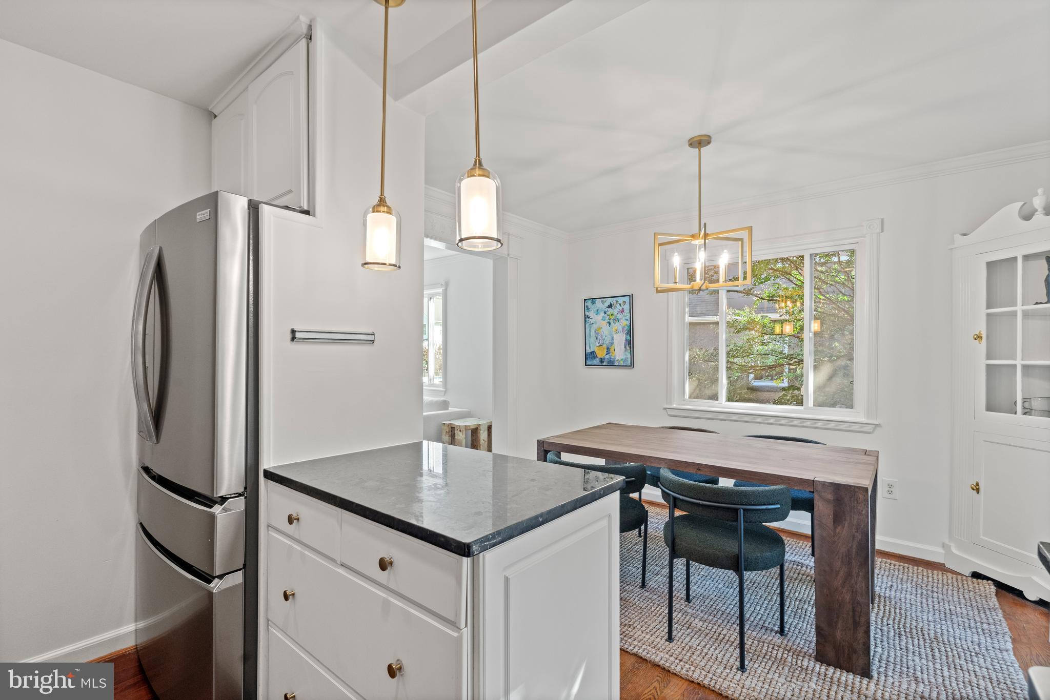 307 East Oxford Avenue, Unit 1/2 Alexandria, VA 22301 - Photo 9 of 34 a kitchen with stainless steel appliances a dining table chairs and a refrigerator