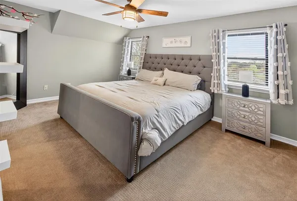 a bedroom with bed and a night stand