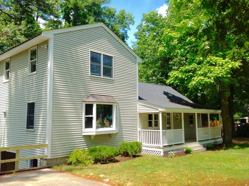 16 Cedar Road Groton, MA 01450 - Photo 1 of 25 a front view of a house with a yard
