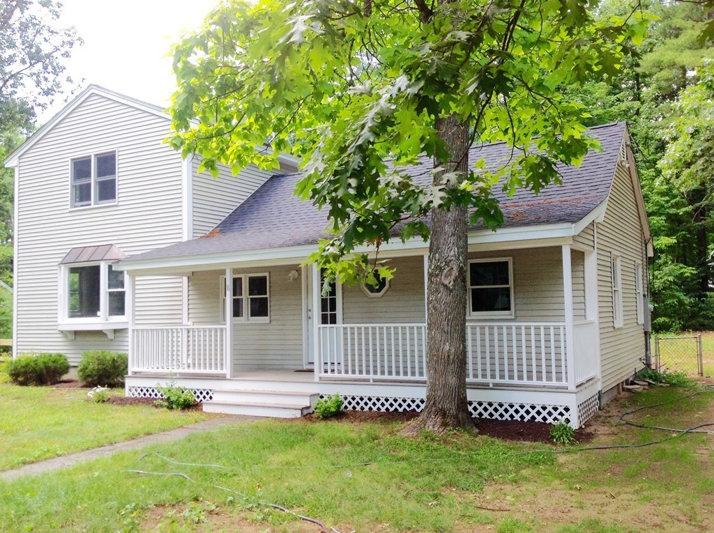 16 Cedar Road Groton, MA 01450 - Photo 2 of 25 a front view of a house with a garden and yard