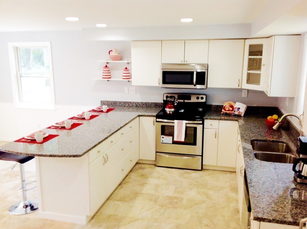 16 Cedar Road Groton, MA 01450 - Photo 8 of 25 a kitchen with stainless steel appliances kitchen island granite countertop a sink and cabinets