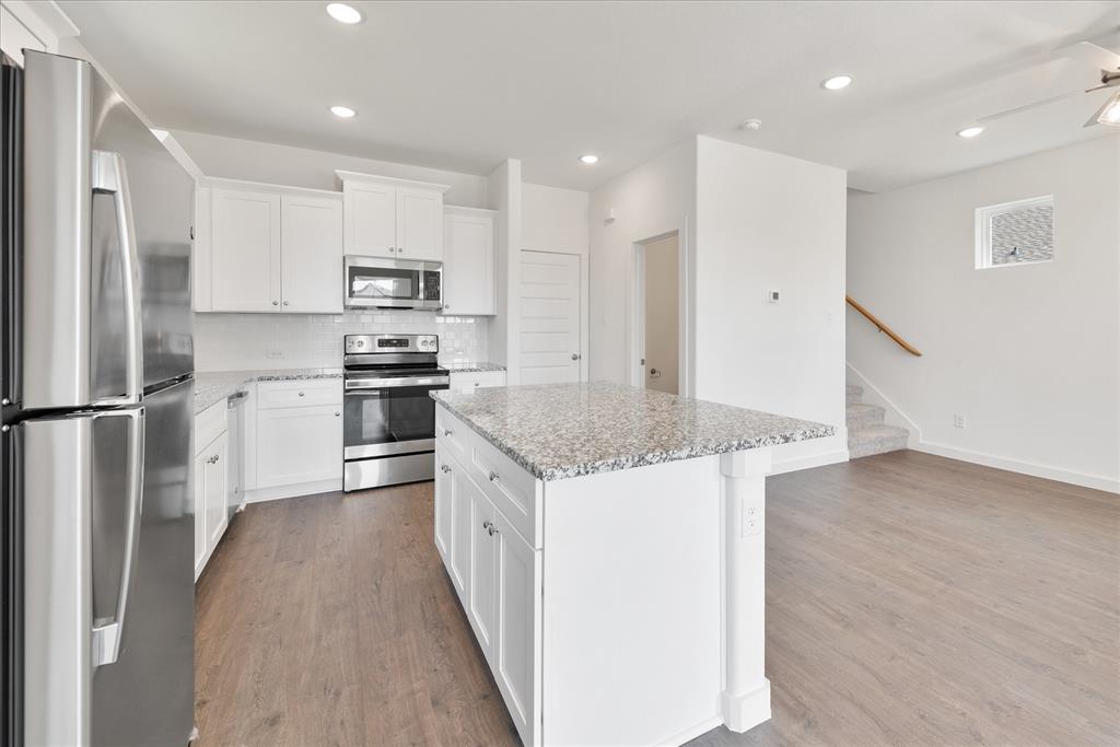 1215 Chestnut Court Runaway Bay, TX 76426 - Photo 13 of 28 a kitchen with stainless steel appliances granite countertop a refrigerator a stove and a sink