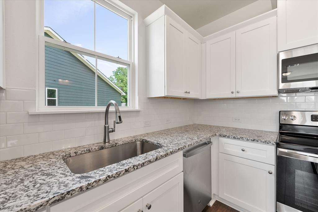 1215 Chestnut Court Runaway Bay, TX 76426 - Photo 14 of 28 a kitchen with white cabinets sink and white appliances