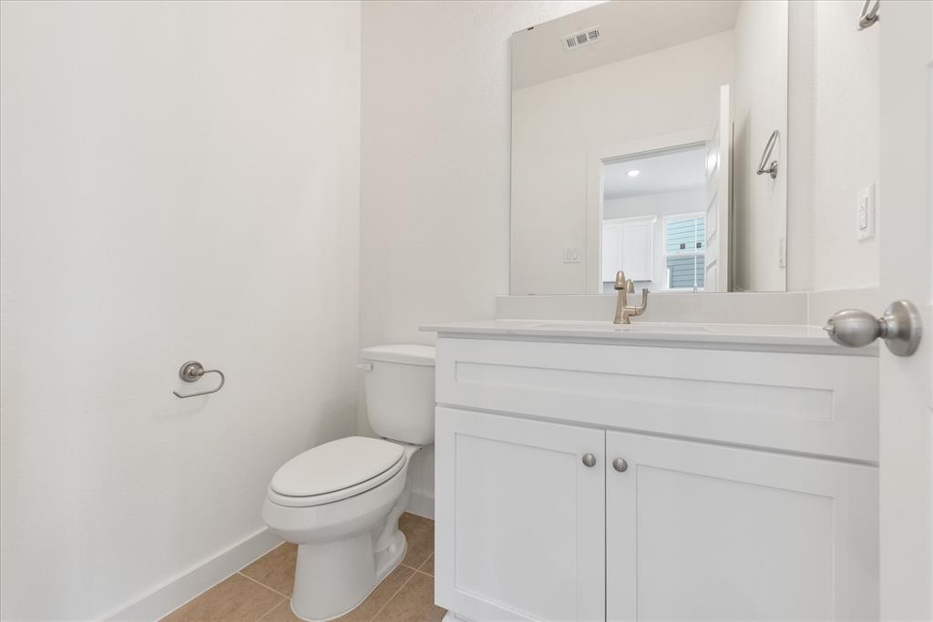 1215 Chestnut Court Runaway Bay, TX 76426 - Photo 16 of 28 a bathroom with a sink a toilet and a mirror