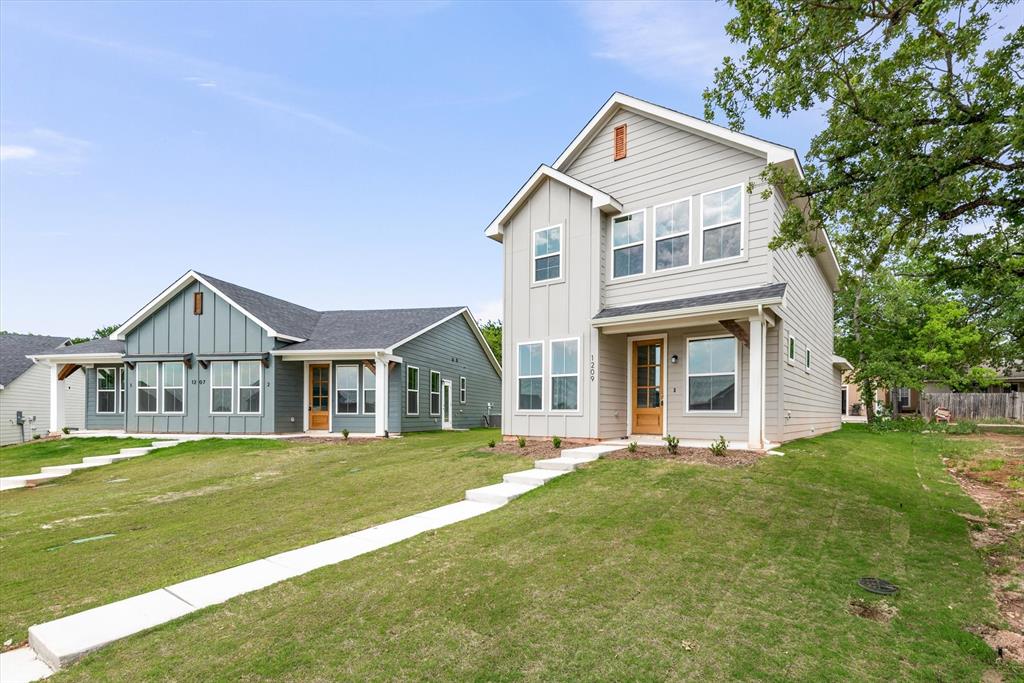 1215 Chestnut Court Runaway Bay, TX 76426 - Photo 2 of 28 a front view of a house with a yard and trees