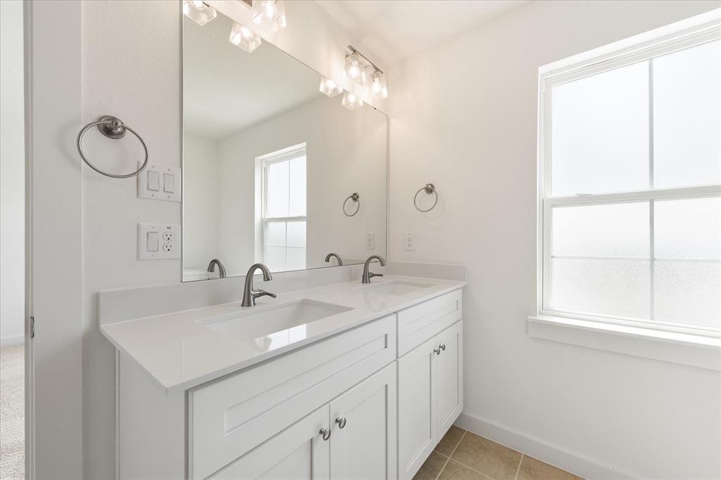 1215 Chestnut Court Runaway Bay, TX 76426 - Photo 22 of 28 a bathroom with a sink and a mirror