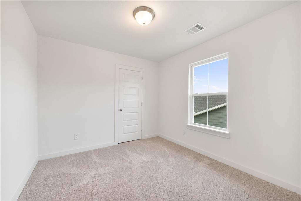 1215 Chestnut Court Runaway Bay, TX 76426 - Photo 23 of 28 an empty room with windows