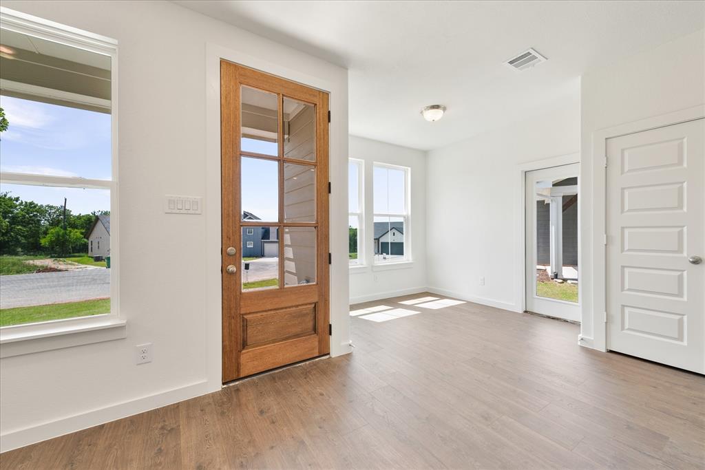 1215 Chestnut Court Runaway Bay, TX 76426 - Photo 5 of 28 wooden floor in an empty room with a window