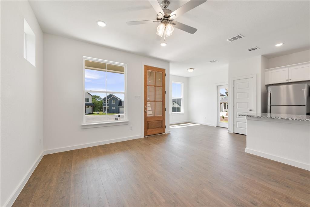 1215 Chestnut Court Runaway Bay, TX 76426 - Photo 8 of 28 a view of an empty room with a window and wooden floor