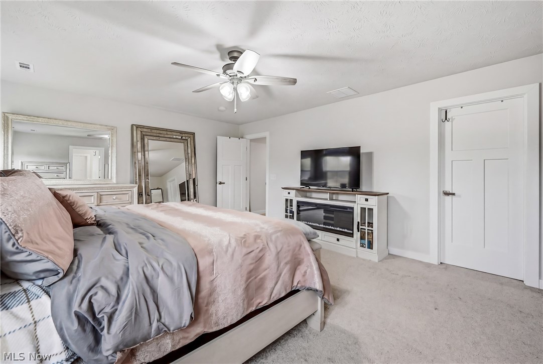 5358 Walnut Rdg Lane Sheffield Lake, OH 44054 - Photo 24 of 50 Spacious bedroom featuring light-colored carpet flooring, a ceiling fan with integrated lighting, and white trim