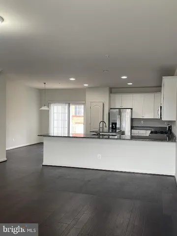 a view of kitchen with stainless steel appliances kitchen island sink and stove