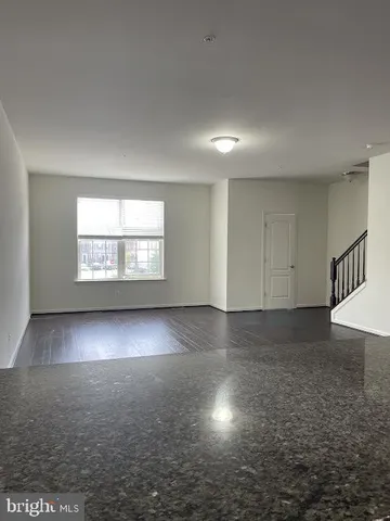 an empty room with floor to ceiling windows and fireplace