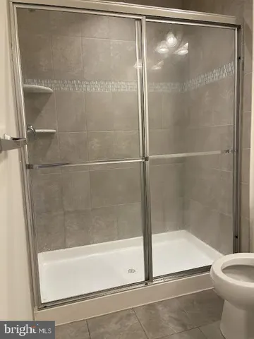 a bathroom with a shower and a toilet