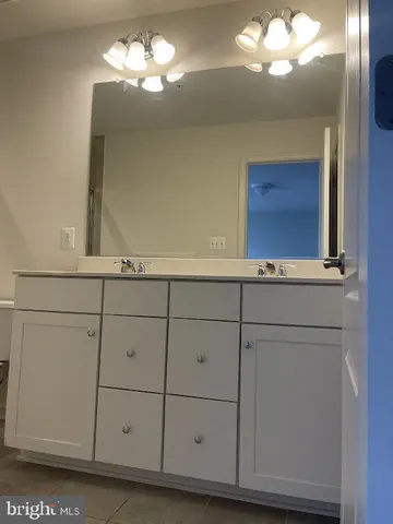 a view of a kitchen with cabinets and wooden floor