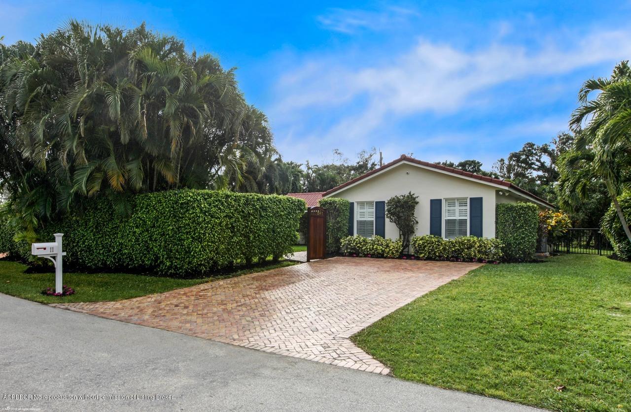 11 Ridge Boulevard Ocean Ridge, FL 33435 - Photo 23 of 26 a front view of a house with a yard and garage