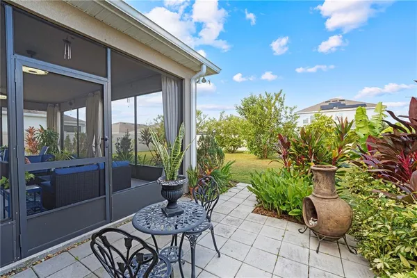 a view of a patio with table and chairs and potted plants
