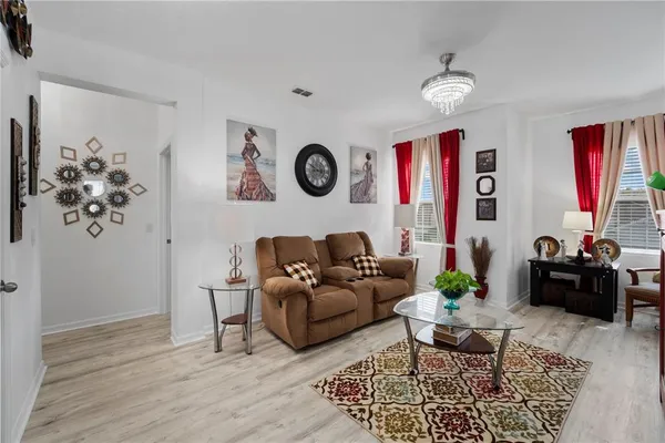 a living room with furniture and wooden floor
