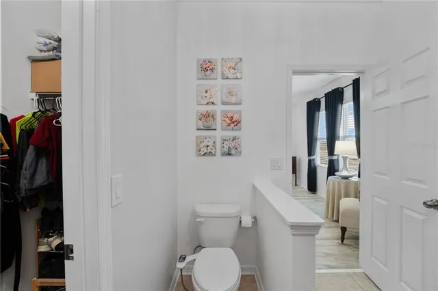 a white toilet sitting next to a bathroom sink