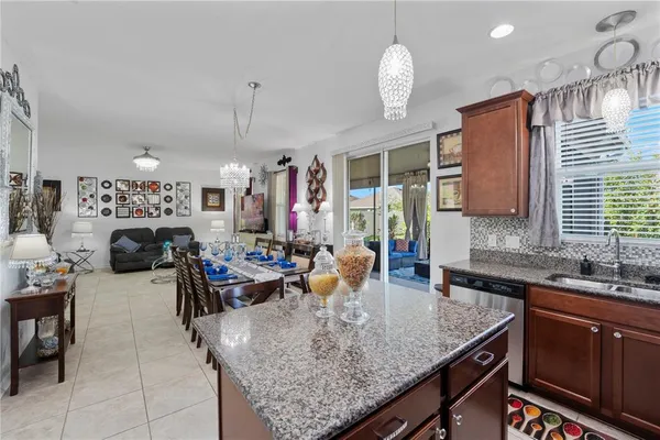 a kitchen with sink refrigerator and couches
