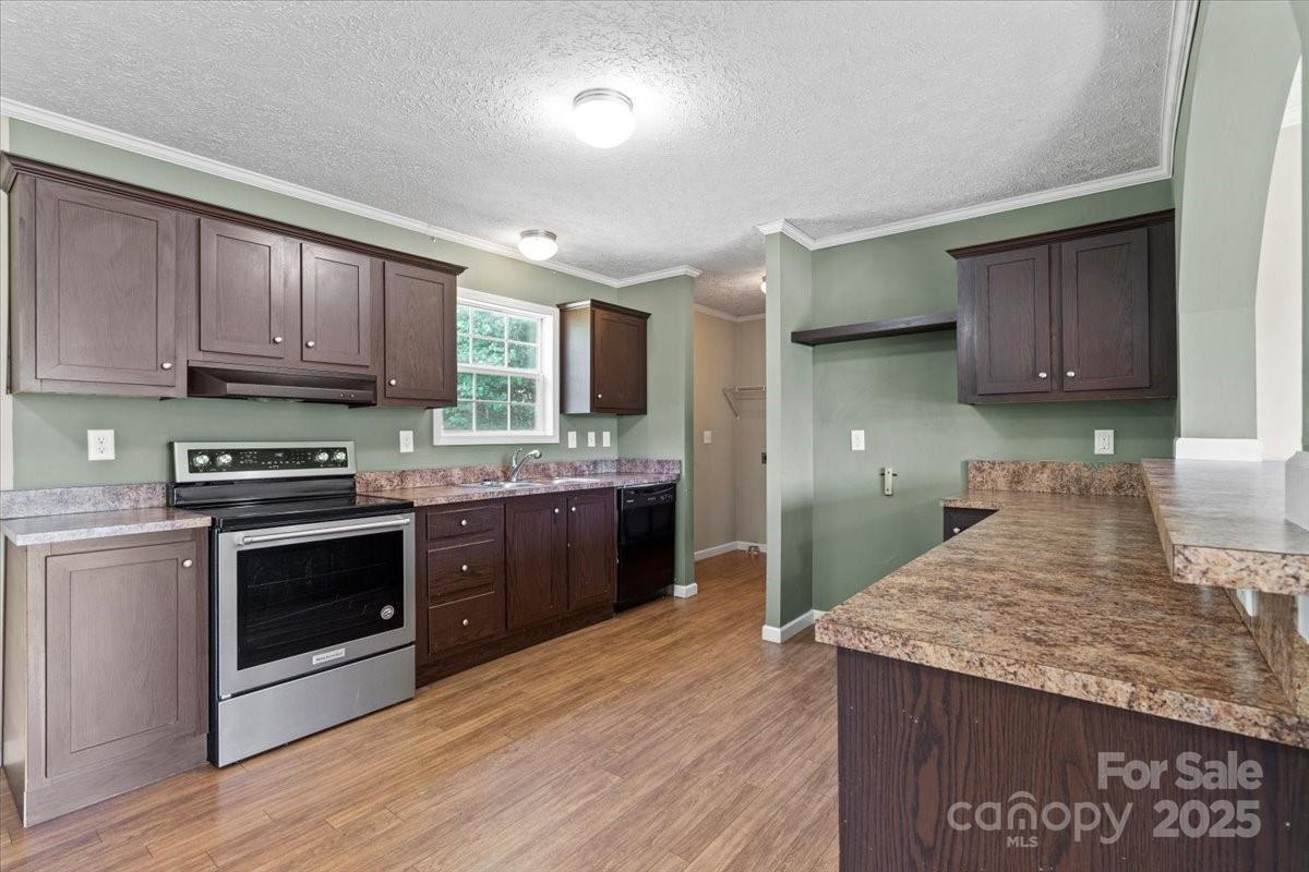 138 Dayton Road Dallas, NC 28034 - Photo 11 of 26 a kitchen with stainless steel appliances granite countertop a stove a sink and a microwave