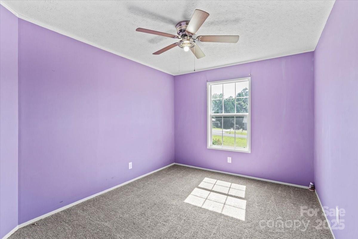 138 Dayton Road Dallas, NC 28034 - Photo 8 of 26 an empty room with windows and fan