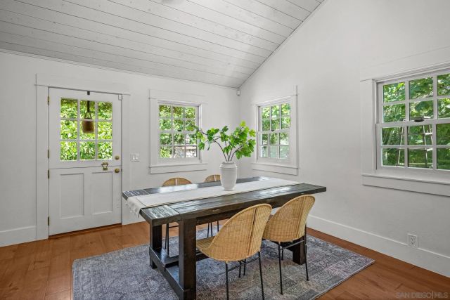 a dining room with furniture and wooden floor