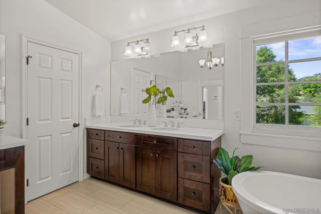 a view of a bathroom with tub and shower