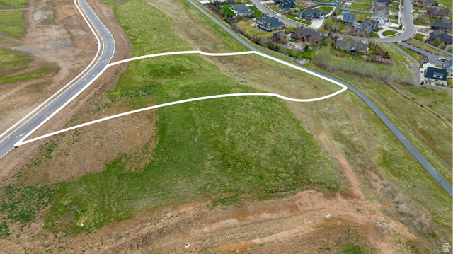2042 Valley Drive, Unit 57 Mapleton, UT 84664 - Photo 3 of 18 Expansive undeveloped lot featuring a paved road frontage and green space