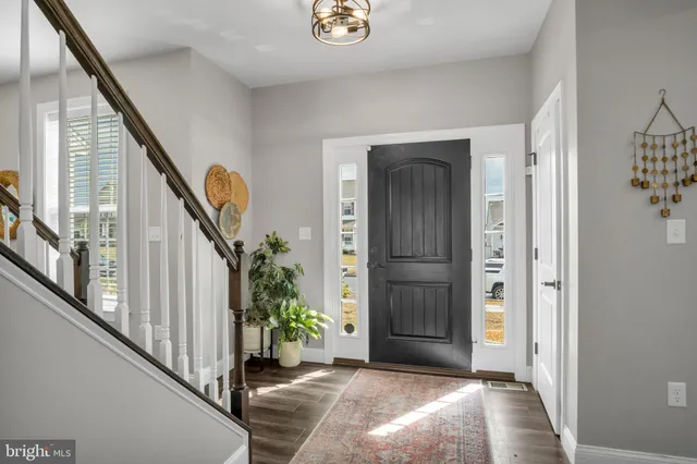 a view of entryway with wooden floor and stairs
