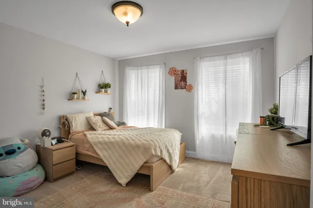 a bedroom with bed and window