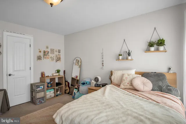a bedroom with bed and a chandelier