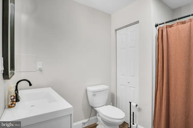 a bathroom with a toilet sink and shower