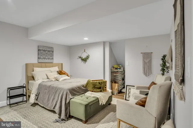 a bedroom with furniture and wooden floor