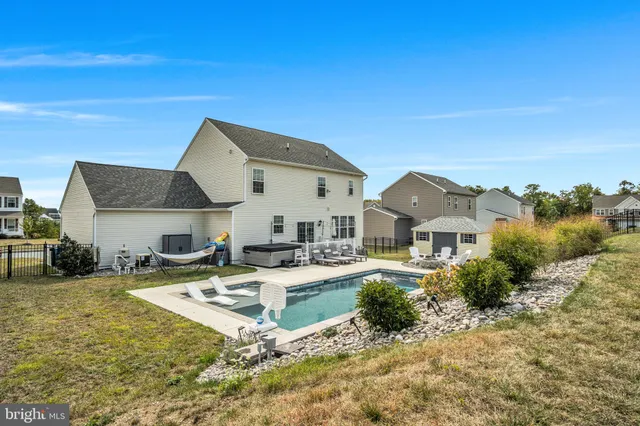 a view of swimming pool with outdoor seating and city view