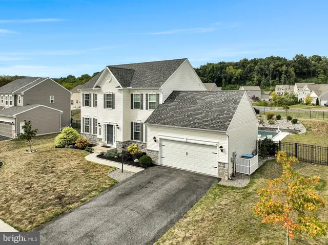 a view of a patio with couches table and chairs under an umbrella