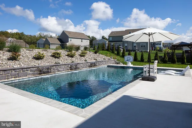 a view of a terrace with chairs and umbrella