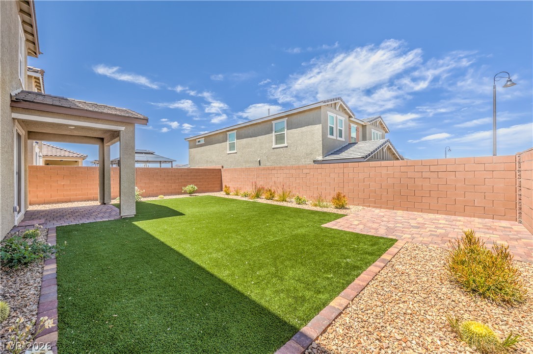 3782 Alla Rocca Avenue Henderson, NV 89044 - Photo 40 of 55 This private yard offers low-maintenance landscaping and an inviting covered patio, perfect for outdoor living.