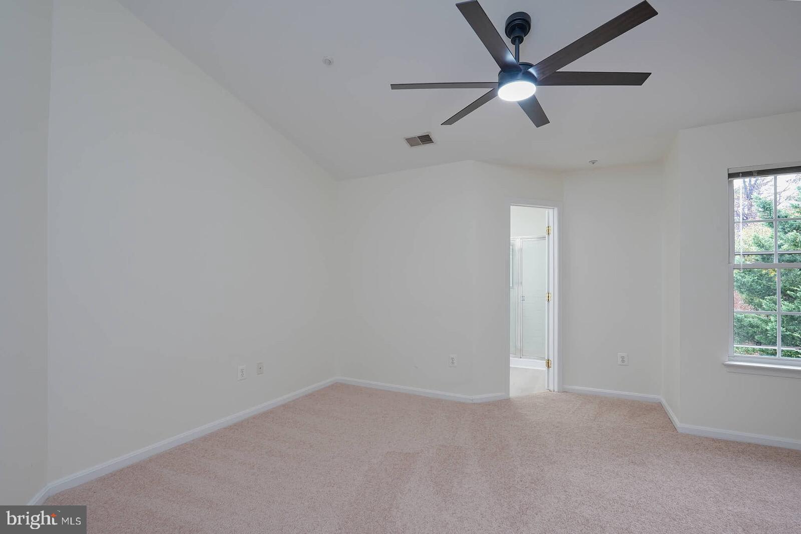 7802 Canter Court Severn, MD 21144 - Photo 17 of 41 an empty room with a window and a fan