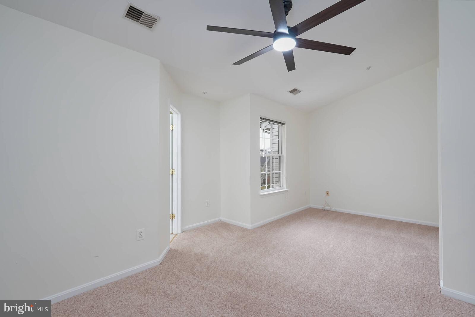 7802 Canter Court Severn, MD 21144 - Photo 18 of 41 an empty room with a window and a fan