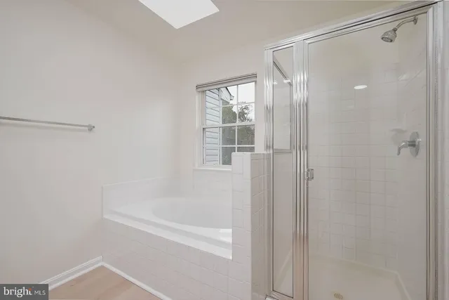 a bathroom with a shower and a bath tub