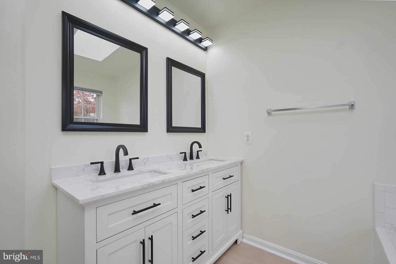 7802 Canter Court Severn, MD 21144 - Photo 22 of 41 a bathroom with 2 sink and a mirror