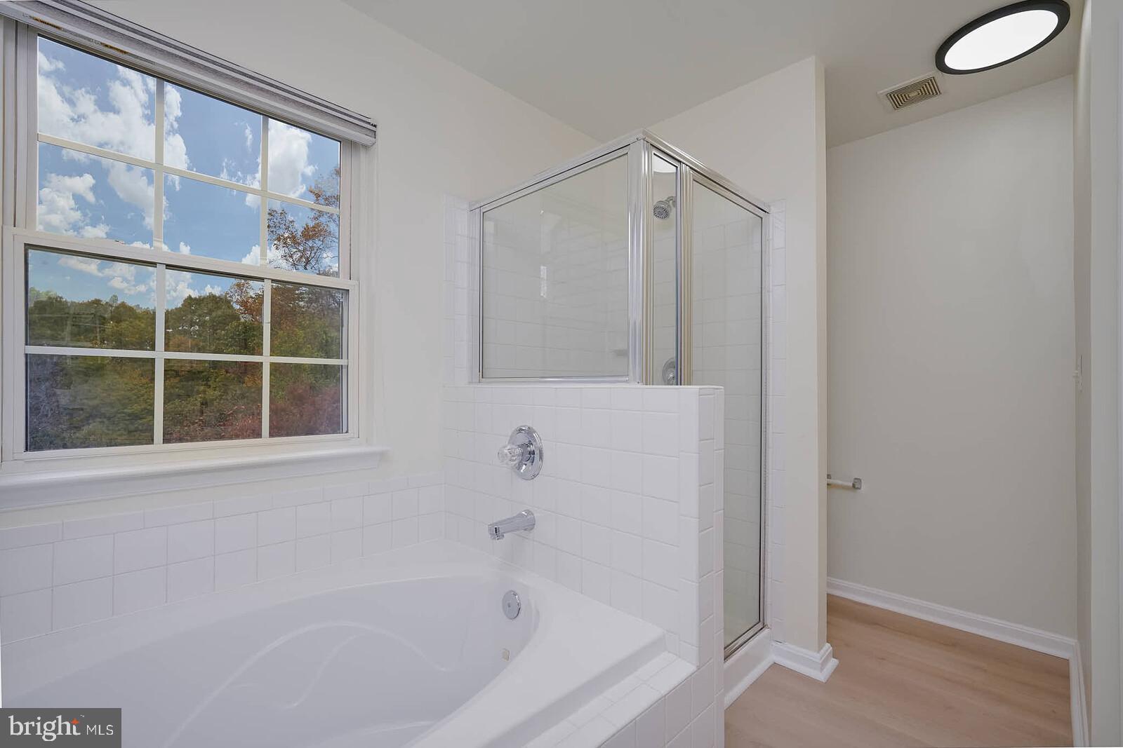 7802 Canter Court Severn, MD 21144 - Photo 23 of 41 a bathroom with a bathtub and a shower