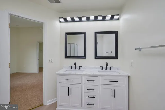 a bathroom with sink two mirror and a