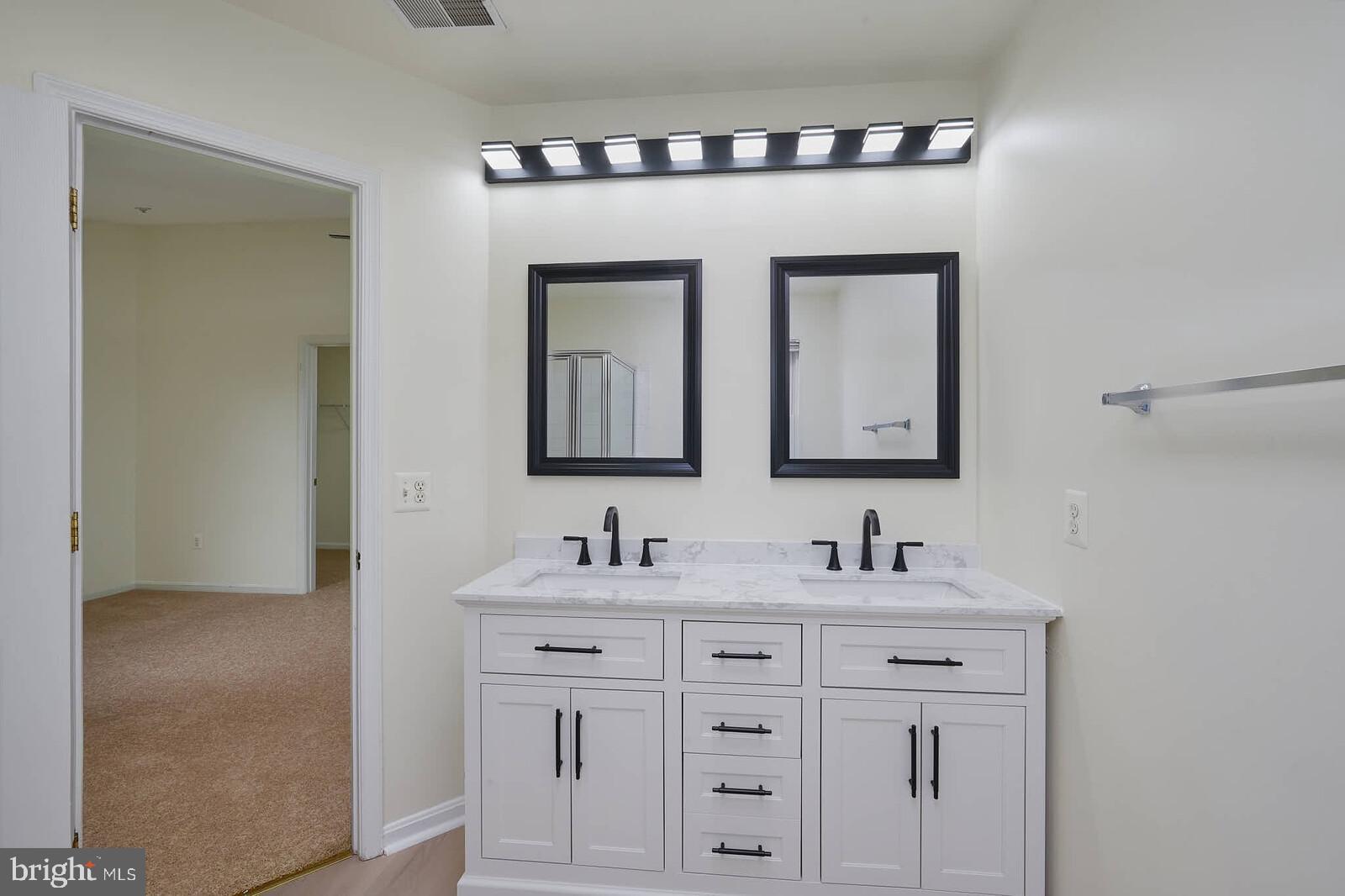 7802 Canter Court Severn, MD 21144 - Photo 24 of 41 a bathroom with sink two mirror and a