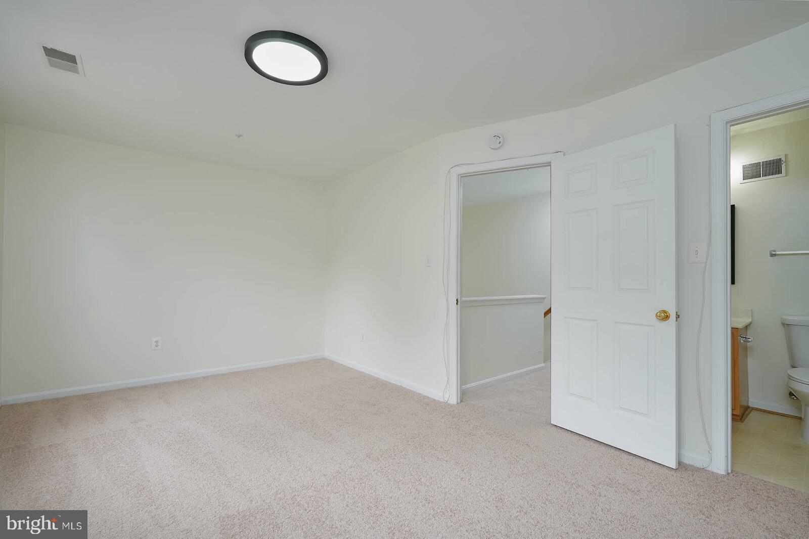 7802 Canter Court Severn, MD 21144 - Photo 29 of 41 an empty room with a bench and vanity