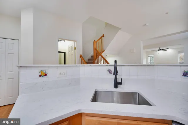 a kitchen with a sink and a mirror