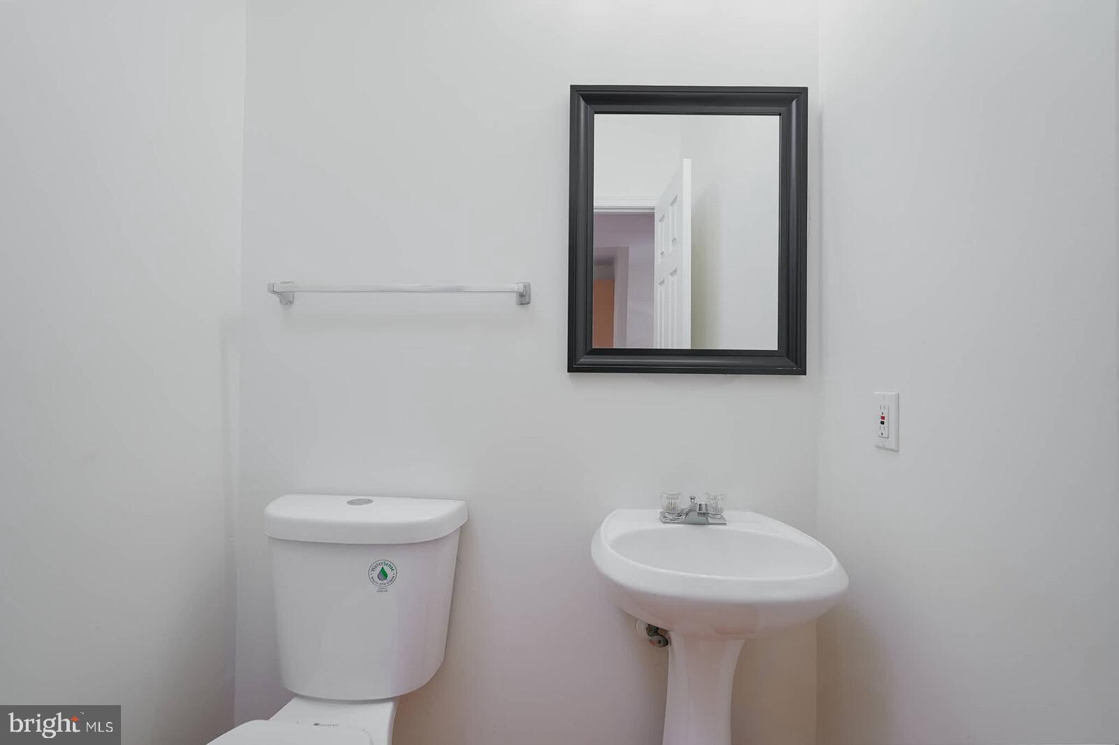 7802 Canter Court Severn, MD 21144 - Photo 9 of 41 a bathroom with a toilet sink and mirror