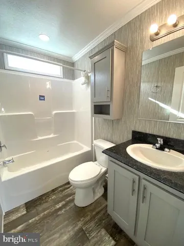 a bathroom with a sink toilet a mirror and shower
