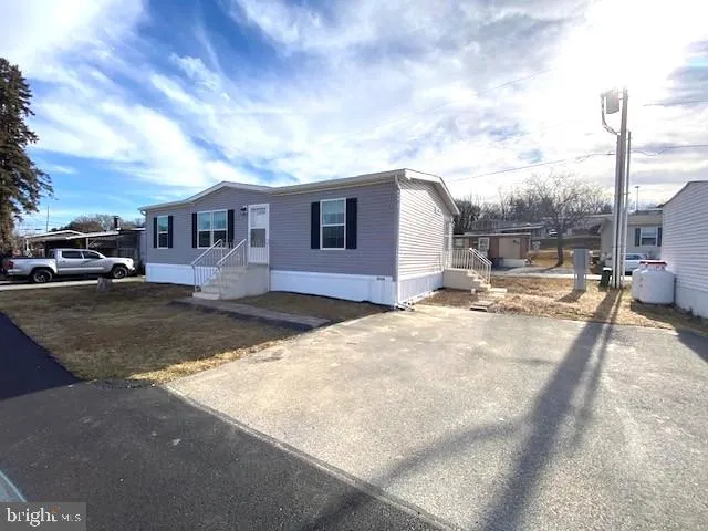 a view of a house with a yard covered in snow